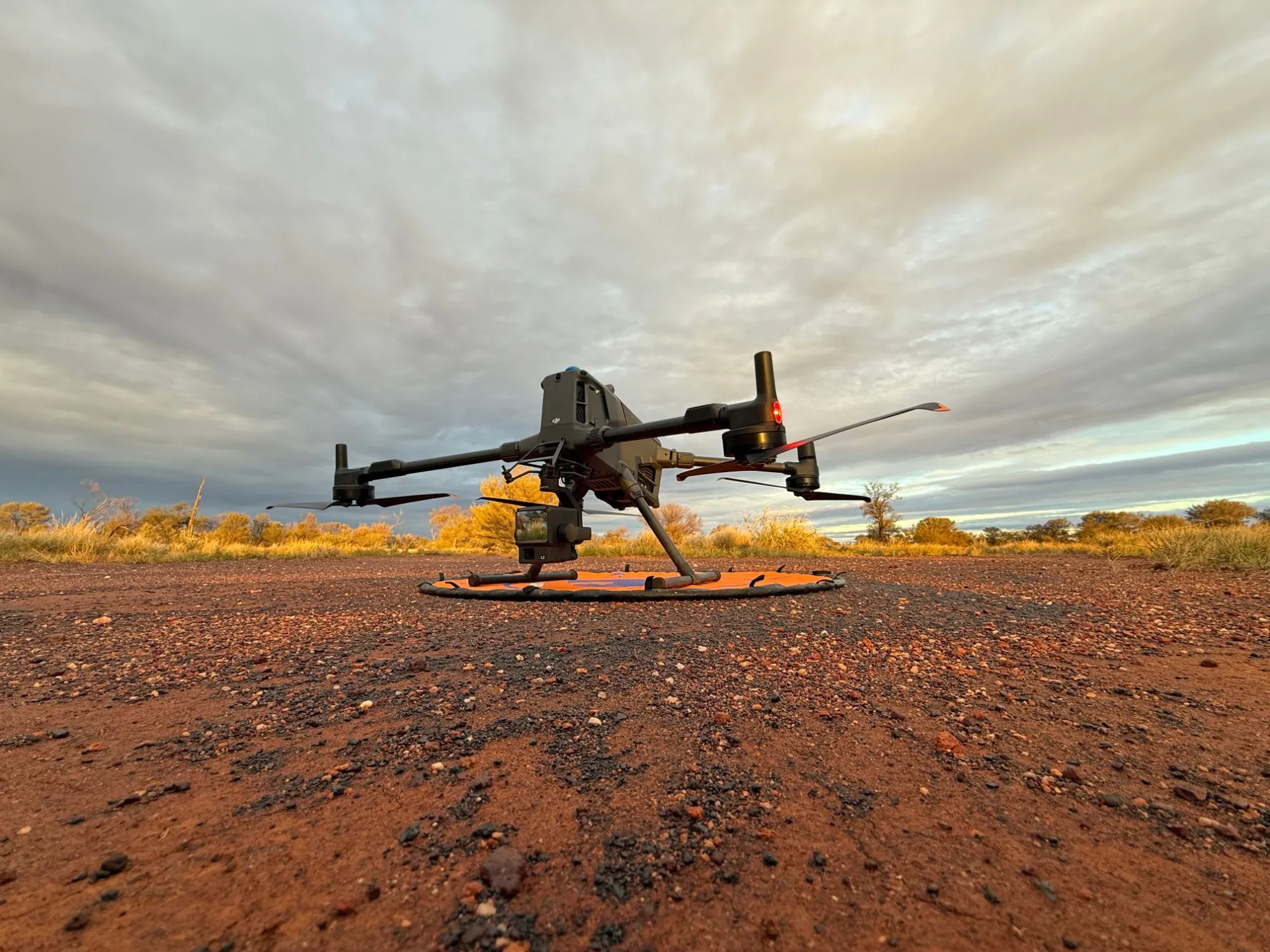 Agile Systems drone on red gravel at sunrise